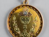 a close up of a gold medal on a white surface