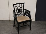 a black chair with a tan cushion on it