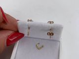 a woman ' s hand holding a ring in a white box