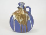 a blue and gold vase with a giraffe on it