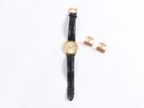 an image of a gold watch and cuff with a black leather strap