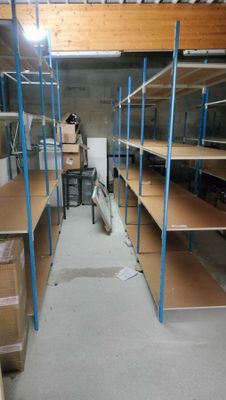 a room with shelves and boxes in it