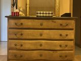 a dresser with a mirror and a lamp on top of it