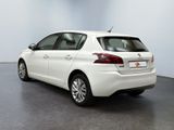 the rear end of a white car parked in a room