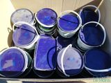 many buckets of blue paint in a cardboard box