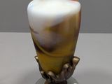 a vase that is sitting on top of a glass plate