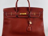 a brown leather handbag with gold hardware and tassel