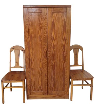 two chairs that are next to a tall wooden cabinet