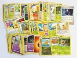 a lot of pokemon cards that are on the table