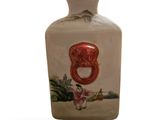 a small vase with a picture of a bear on it