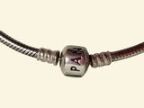 bracelet with a silver bead and a purple bead on a white background