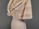 a close up of a mannequin head with a fur stole on it