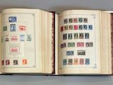 three open books with stamps on them sitting on a table