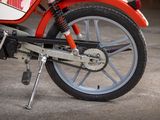 a red and white motorcycle parked in a garage