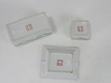 three small white plates and a small white plate