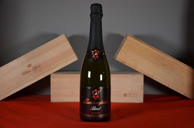 a bottle of wine sitting on a table next to two wooden boxes