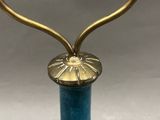 a close up of a blue vase with a gold handle