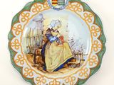a plate with a picture of a woman and a cat on it
