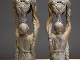 two statues of a boy and a girl holding water in their hands