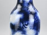 a blue and white vase sitting on a table