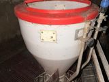 a toilet with a red lid sitting in a dirty room