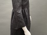a mannequin wearing a black dress and black tights
