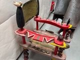a red rocking chair with a bird on top of it