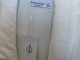 a white shirt hanging on a hanger in a store