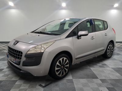 the small silver car is parked in a large room