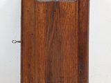 an old wooden cabinet with a door on top of it