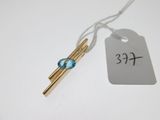 a small blue glass bead hanging from a string