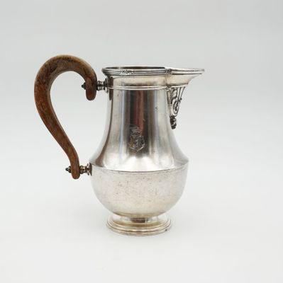an antique silver coffee pot with a wooden handle on a white background