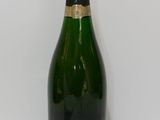 the bottle of champagne is sitting on the table next to the wall