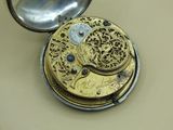 a pocket watch that is sitting on a table