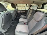 the interior of a small car with four seats and a steering wheel