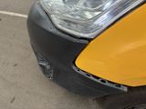 a close up of the front of a car with a dent in it