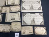 several old paper money bills are displayed on a black table