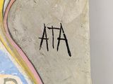 a painting on the wall of a room with a name written on it