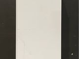 an image of a white refrigerator against a black wall