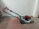a small lawn mower that is sitting on the floor