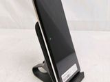 a cell phone that is on a stand on a table