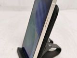 a phone that is sitting on a stand on a table
