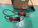 two red jackets sitting on the floor next to a wooden box