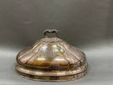 a silver plate with a lid that has a handle on it