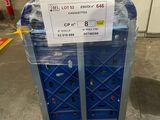 a blue cart with a sign on it in a warehouse