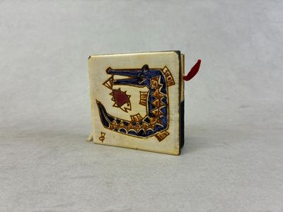 une image représentant un petit livre sur lequel figure la lettre d