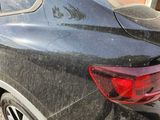 a black car parked on the side of the street