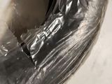a close up of a toilet with a plastic cover on it