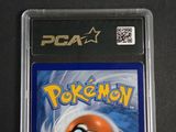 a close up of a pokemon card on a black surface
