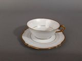 a cup and saucer sitting on a table